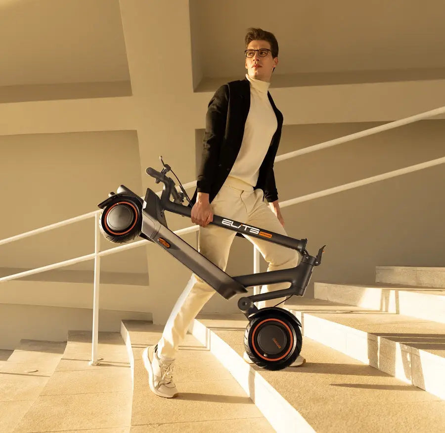 Fashion model posing with a folded ElitePrime E-scooter on a staircase