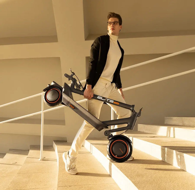 Load image into Gallery viewer, Fashion model posing with a folded ElitePrime E-scooter on a staircase
