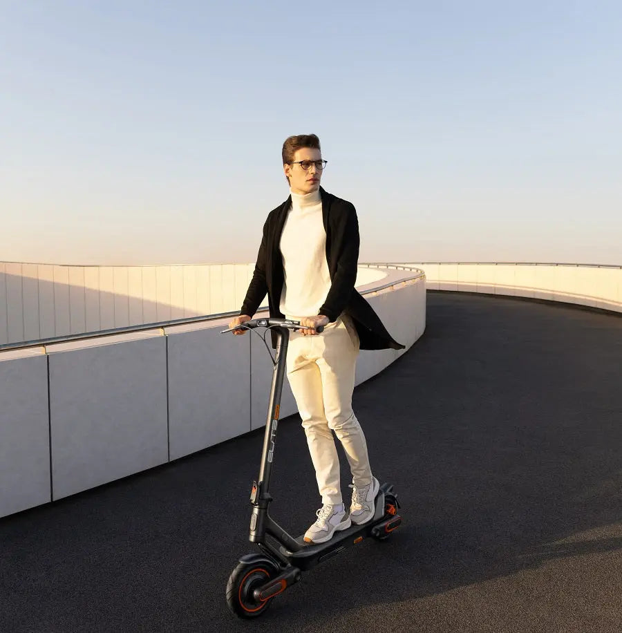 Model riding an ElitePrime electric scooter on the road