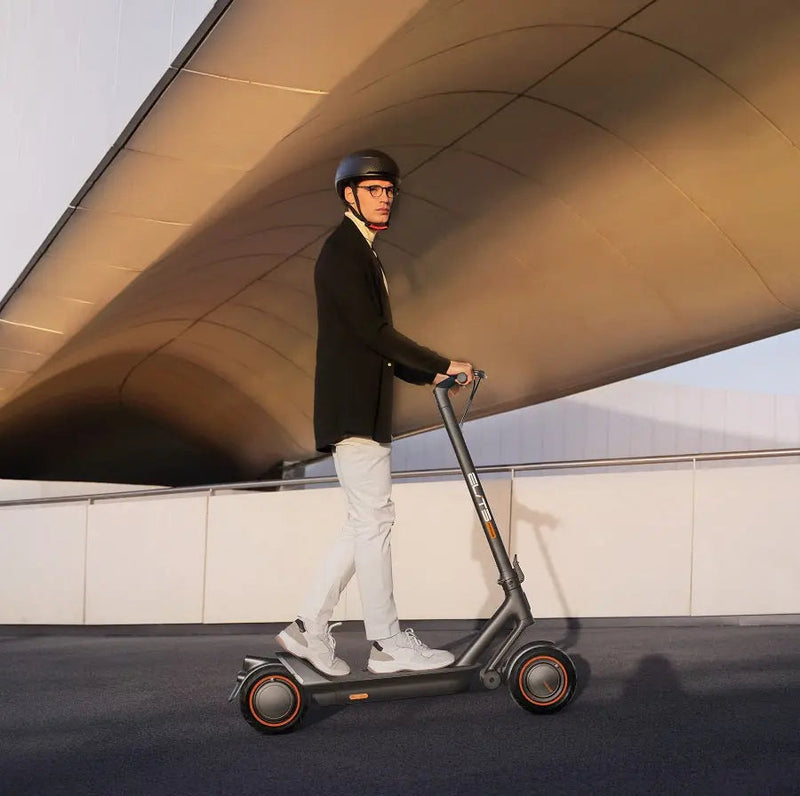 Load image into Gallery viewer, Model riding an ElitePrime electric scooter on the road

